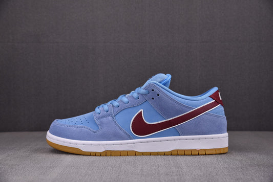 Blue sneaker with a red swoosh logo on a gray background