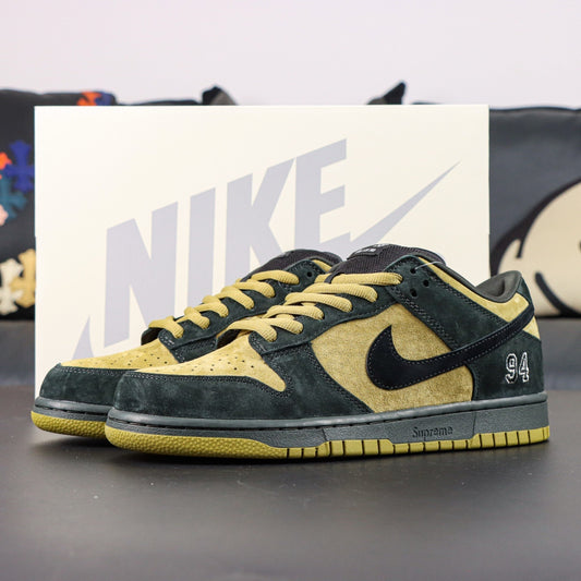 Black and gold sneakers with a Nike box in the background