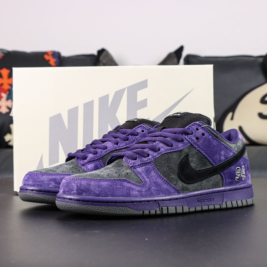 Nike SB Dunk Low Supreme 94 Ink sneaker in purple and gray with black details, showcasing street style and athletic performance.